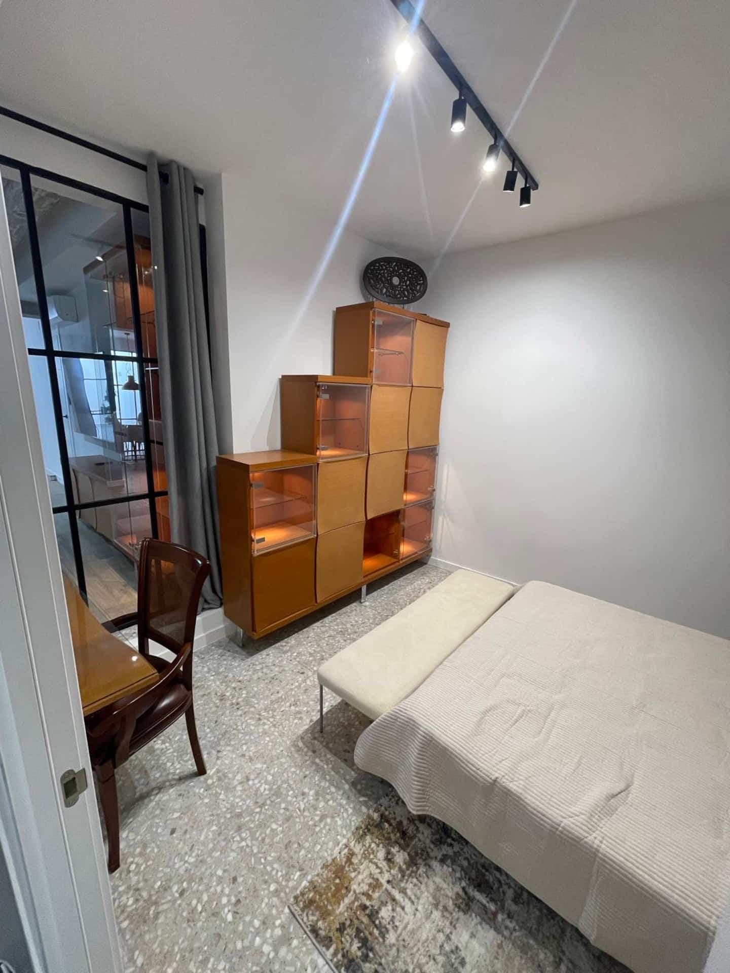 Bedroom 2: shelves and armchair